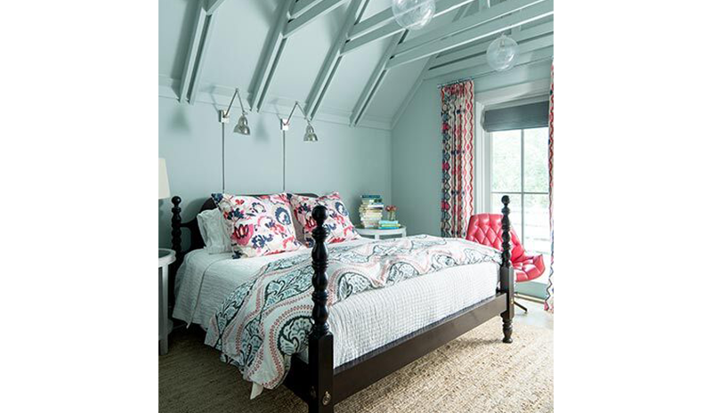 Vibrant blue bedroom with matching industrial ceiling including a large bed with printed bedding. Vibrant blue bedroom with matching industrial ceiling including a large bed with printed bedding.