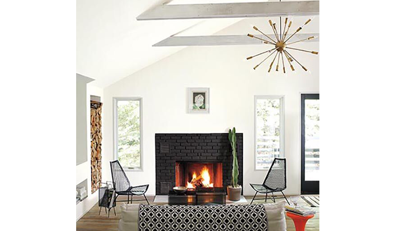 A modern white living room with black brick fireplace and hardwood floors. A modern white living room with black brick fireplace and hardwood floors.
