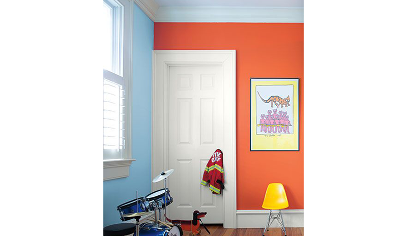 A kid’s room with one orange wall and one blue, white trim and doors. A kid’s room with one orange wall and one blue, white trim and doors.