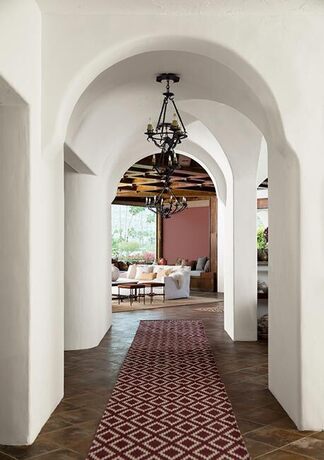 Crisp white painted atrium leading to a warm living room. Crisp white painted atrium leading to a warm living room.