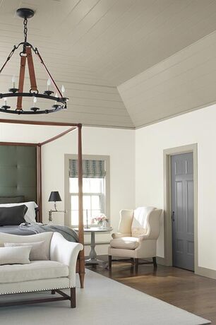 Gray and white bedroom with high ceiling accents and hardwood floors. Gray and white bedroom with high ceiling accents and hardwood floors.