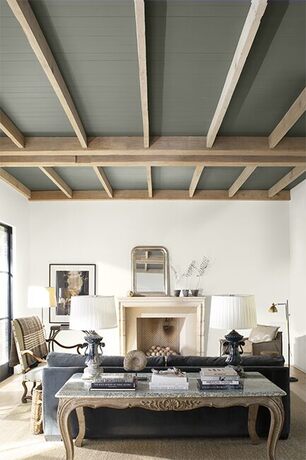 A modern neutral palette living room with high wood paneled ceiling painted in a dramatic gray. A modern neutral palette living room with high wood paneled ceiling painted in a dramatic gray.