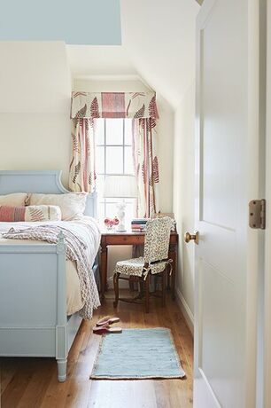 Cozy top floor bedroom with soft light blue ceiling and matching decor. Cozy top floor bedroom with soft light blue ceiling and matching decor.