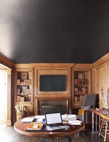 Rustic mahogany study with black ceiling and fireplace. Rustic mahogany study with black ceiling and fireplace.