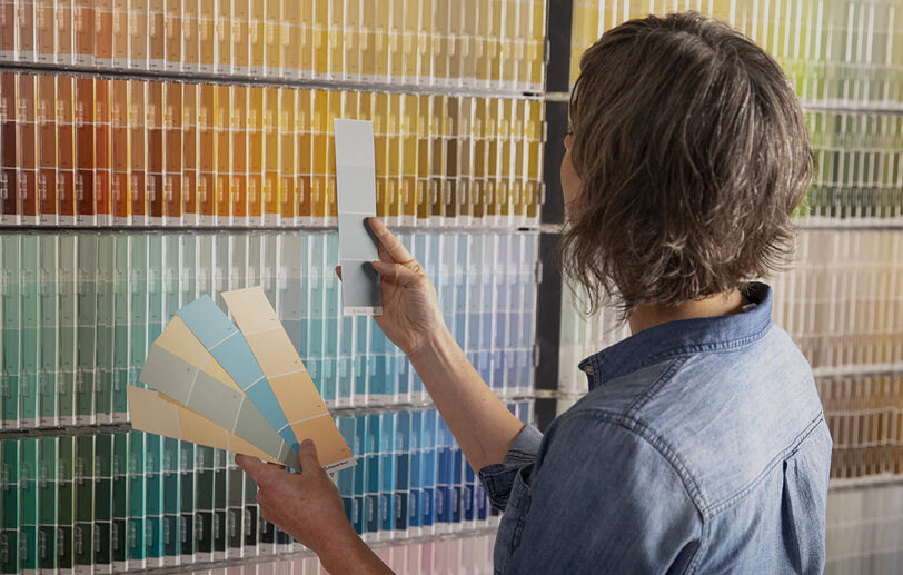 Woman inspecting various paint swatches Woman inspecting various paint swatches