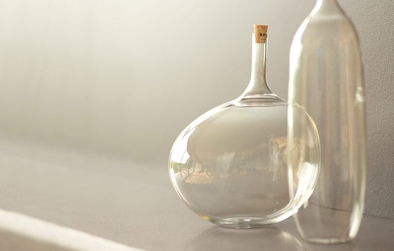 Glass vases set against a wall painted in light griege Barren Plain 2111-60.